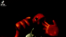 a close up of a bloody monster with a black background .