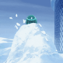 a green sphere is sitting on top of a snow covered mountain