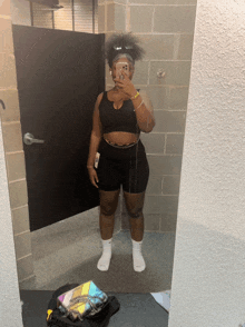 a woman is taking a picture of herself in a mirror