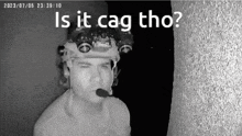 a black and white photo of a man with a microphone on his head and the words is it cag tho on the bottom