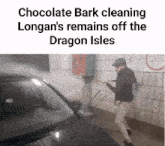 a man is cleaning a car with a high pressure washer