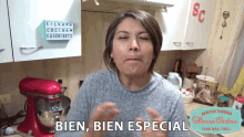 a woman in a kitchen with a sign that says bien
