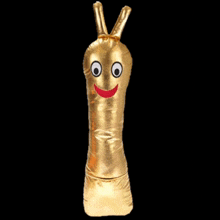 a gold stuffed animal with a red smile on its face