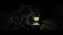 a close up of a man and a woman kissing in a dark room .