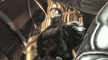 a man with a mask on his face is standing next to a statue