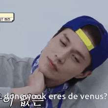 a man wearing a blue hat and a bandana says dongwook eres de venus in a foreign language
