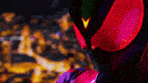a close up of a person wearing a superhero costume with a red mask .