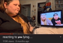 a woman is sitting in front of a laptop with the words " reacting to you lying " on the bottom