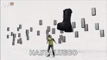 a black boot with the words `` hasta luego '' written on it is surrounded by blocks .