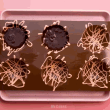 a tray of chocolate covered cupcakes with the words mr.cakes written on the bottom