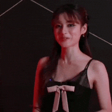 a woman in a black tank top with the word dumb in white letters