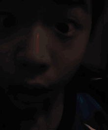 a close up of a young boy 's face with his eyes wide open .