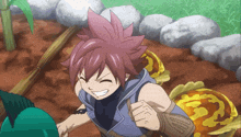 a boy with red hair and a blue vest is smiling