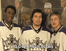 a group of hockey players are standing next to each other in front of a painting of a hockey player .