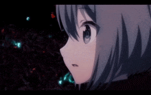 a close up of a girl 's face with a few lights behind her