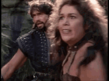 a man and a woman are standing next to each other