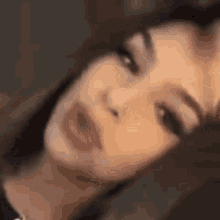 a close up of a woman 's face with her eyes closed and her mouth open .