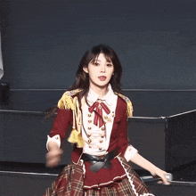 a woman in a red and white outfit is dancing
