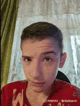 a young boy wearing a red shirt that says w on it