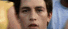 a close up of a man 's face with a blurry background