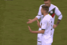 a soccer player wearing a white jersey with the number 5 on it