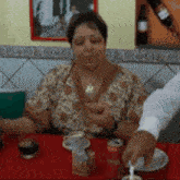 a woman is sitting at a table with a can of coca cola