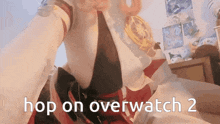 a woman sitting on a bed with the words hop on overwatch 2 written on the bottom
