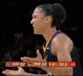 a basketball player stands in front of a scoreboard that says was 62