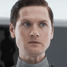 a close up of a man 's face with his eyes closed