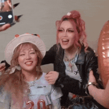 a woman wearing a hat with the number 20 on it laughs