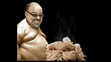 a man with glasses is holding a pile of junk food