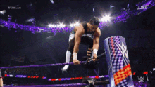 a wrestler in a purple ring with the word live on the bottom