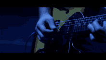 a close up of a person 's face in a dark blue room