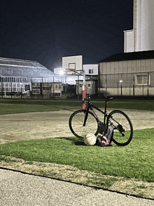 a bicycle with a bag that says shark on it sits on the grass