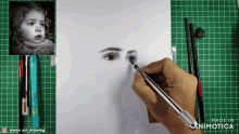 a person is drawing a girl 's face with a made in animatica pen