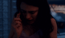 a woman is talking on a cell phone with a samsung logo on it