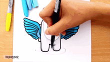 a person is drawing a unicorn with wings on a piece of paper with drawbook written on the bottom