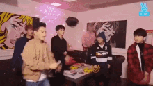 a group of young men are dancing together in a room .