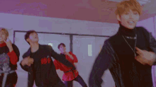 a group of young people are dancing in a hallway with a coke machine in the background