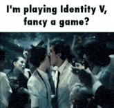 a man and woman kissing in a crowd with the caption i 'm playing identity v fancy a game ?