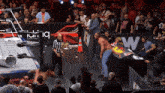 a wrestling ring with a sign that says aew in the background