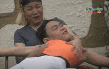 a woman is putting her hands on a man 's stomach while watching kapamilya live