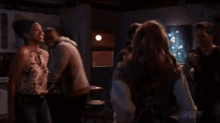 a group of people are dancing in a kitchen with the letters ctv on the bottom right