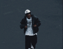 a man wearing a ny hat and a t-shirt with a picture of a dog on it