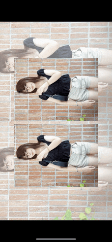 a woman is standing in front of a brick wall with a reflection of herself in the wall