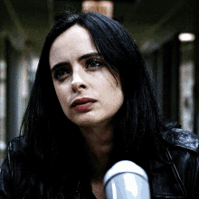 a close up of a woman 's face with dark hair