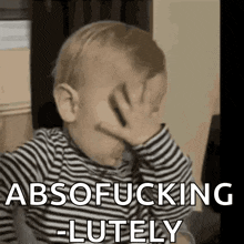 a baby in a striped shirt is covering his face with his hand and says absofucking -lutely