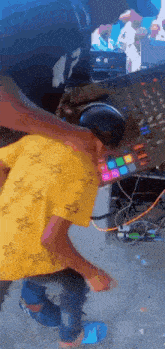 a young boy is standing in front of a dj mixer .