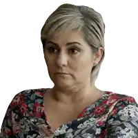 a woman wearing a floral shirt is making a face