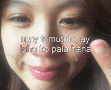 a close up of a woman 's face with the words may tumutulo ay luha ko pala haha above her